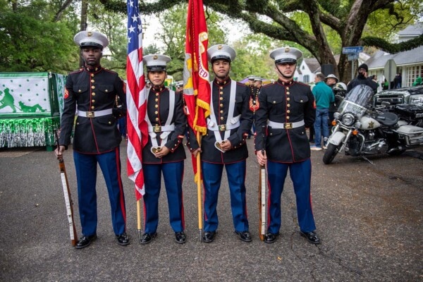 A group of 4 Marines in dress uniforms act as the color guard during the 2023 Wearin' of the Green parade