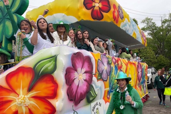 A float full of riders having a great time riding in the 2023 Wearin' of the Green Parade
