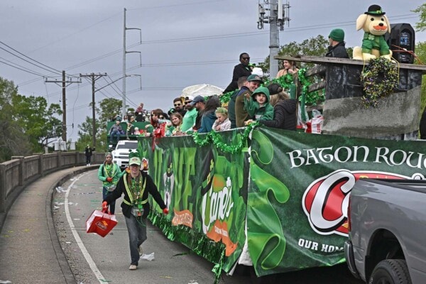 The Cane's float crosses over the Perkins Rd overpass during the 2023 parade