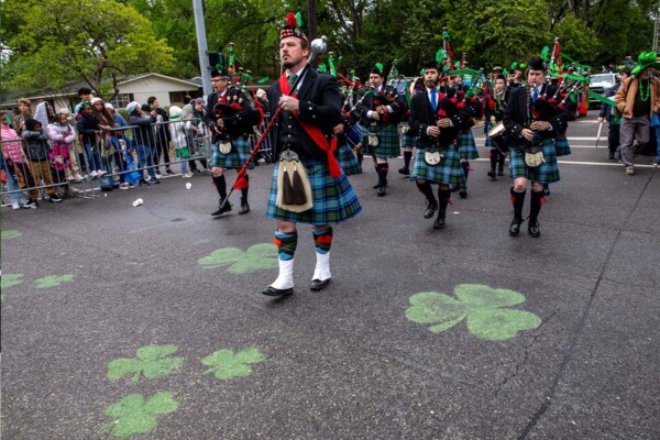 Irish bagpipers in kilts marching during the 2023 St. Patrick's Day Parade