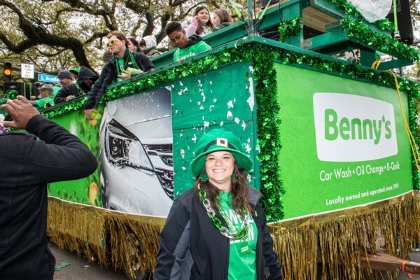 A walker poses next to a float during the 2023 parade