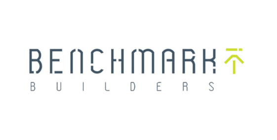 Logo with the text "Benchmark Builders" in a modern font, accompanied by a small green icon resembling an upward arrow to the top right, symbolizing home growth and improvement.